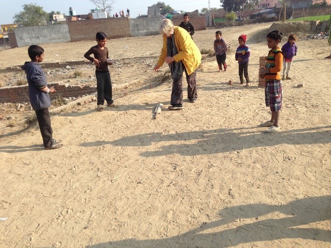 Narda hits a six in a cricket game with local children